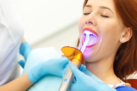 woman being treated by laser dentistry
