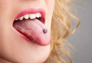 Woman has a piercing in the language