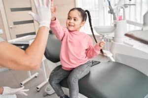 Happy girl at the dentist chair.