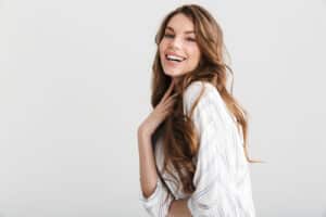 caucasian woman posing and laughing at camera