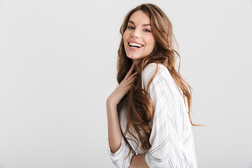 caucasian woman posing and laughing at camera