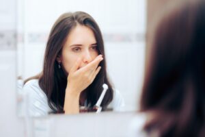 Woman,Holding,Toothbrush,Having,A,Toothache,Looking,In,The,Mirror.