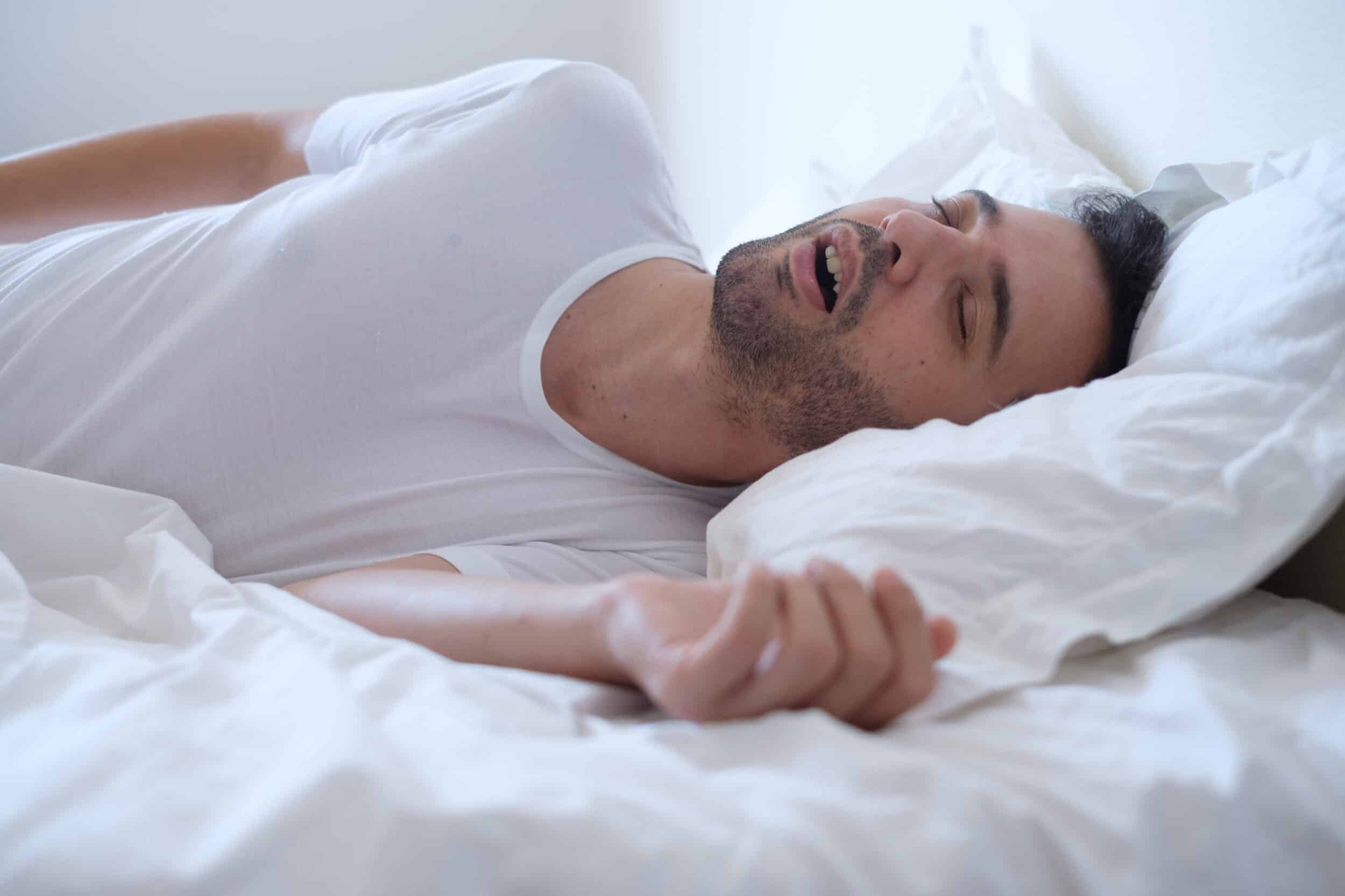 Man snoring while sleeping due to sleep apnea